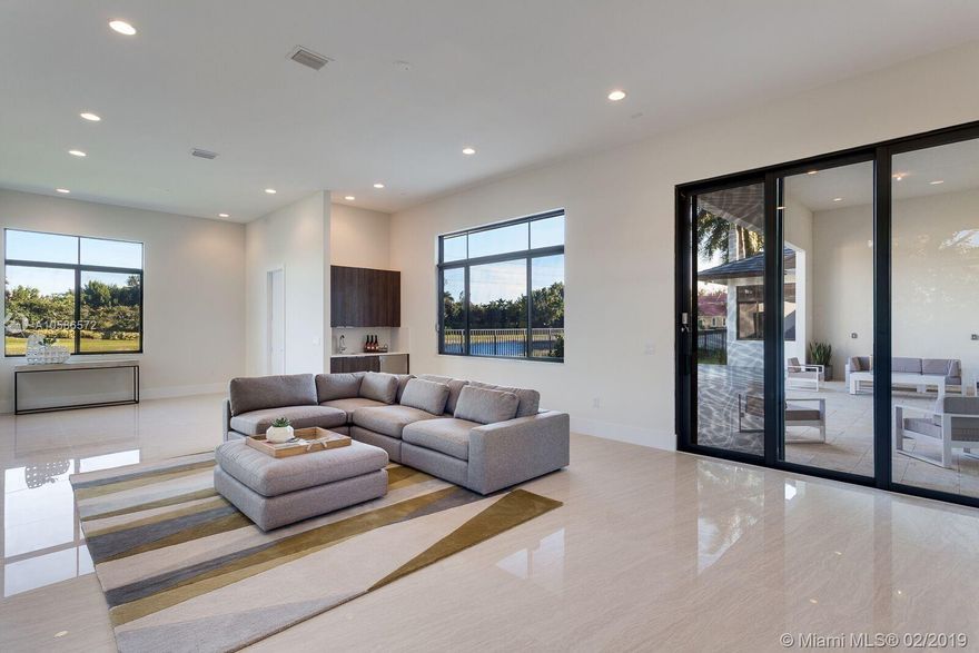 BRAND NEW MODEL HOME - Exquisite contemporary one-story home in The Shores at Windmill Reserve, Weston's premier private guard-gated neighborhood of just 20 exclusive homes! Built by award-winning Lowell Homes, this spacious model features a great room with adjacent office/den and expansive water and pool views. Luxurious kitchen features a huge centerpiece island w/seating and top of the line Jenn Air appliances. Kitchen connects to a large open family room w/ wet bar and pool bath. Master suite has sitting room, generous walk-in closets, makeup vanity, exceptionally huge bath complete with soaking tub and showpiece shower! Secondary bedrooms are large. Home also features laundry room and separate 2 car + 1 Car Garages. A perfect 10 - This is a MUST SEE HOME! Sq.Ft per plans.