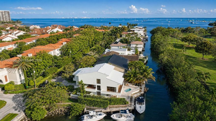 Rare opportunity to own a prime Coconut Grove waterfront home with direct bay access and no bridges to the bay. Located on a coveted corner lot with water on both sides (80' private seawall), this one-of-a-kind 4-bedroom, 4.5-bath + den/loft residence offers the best of Grove living just steps from downtown Coconut Grove and adjacent to Kennedy Park. The home features soaring vaulted ceilings with exposed beams, a bright open layout, a large chef’s kitchen, and a spacious dining room designed for effortless entertaining. The private primary suite spans its own level and includes a dedicated office, library, or additional lounge space, as well as a private rooftop terrace. Complete with a saltwater soaking pool and set on a 6,420 sf lot, this is a truly special waterfront property in one of Miami’s most sought-after neighborhoods.