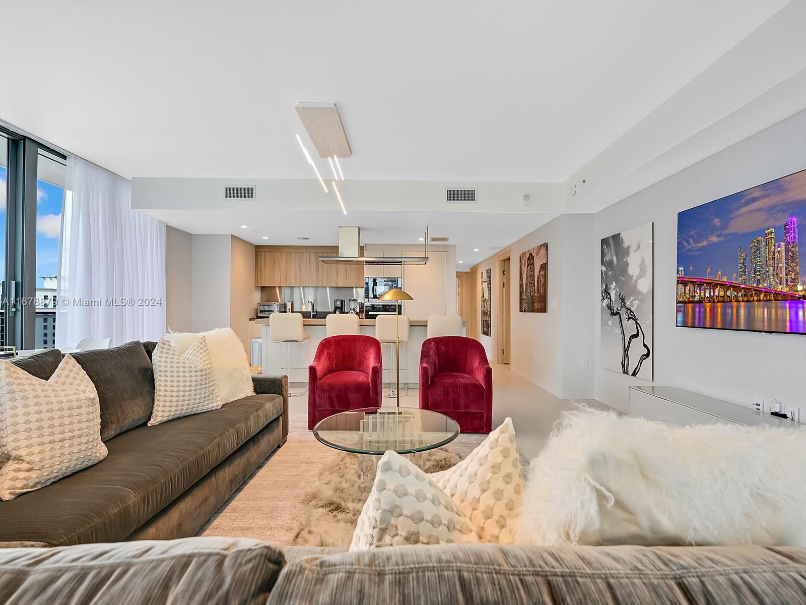 Impeccable with outstanding taste, fully furnished unit includes three bedrooms, 3.5 baths and a showstopper of a great room, with 9-foot ceilings and a wall of glass to frame the spectacular view at night. Designer Robert Clydesdale of Los Angeles California had the cityscape view in mind when choosing the original art work by Glenn David, paints, furnishings and lighting. The refined living space contains top of the line Miele appliances, brand new large screen televisions, state of the art building electronics, Nest system thermostat, Italian doors, marble finishes, custom made closets & motorized window treatments. The unit includes 2 reserved parking spots and 1 valet.