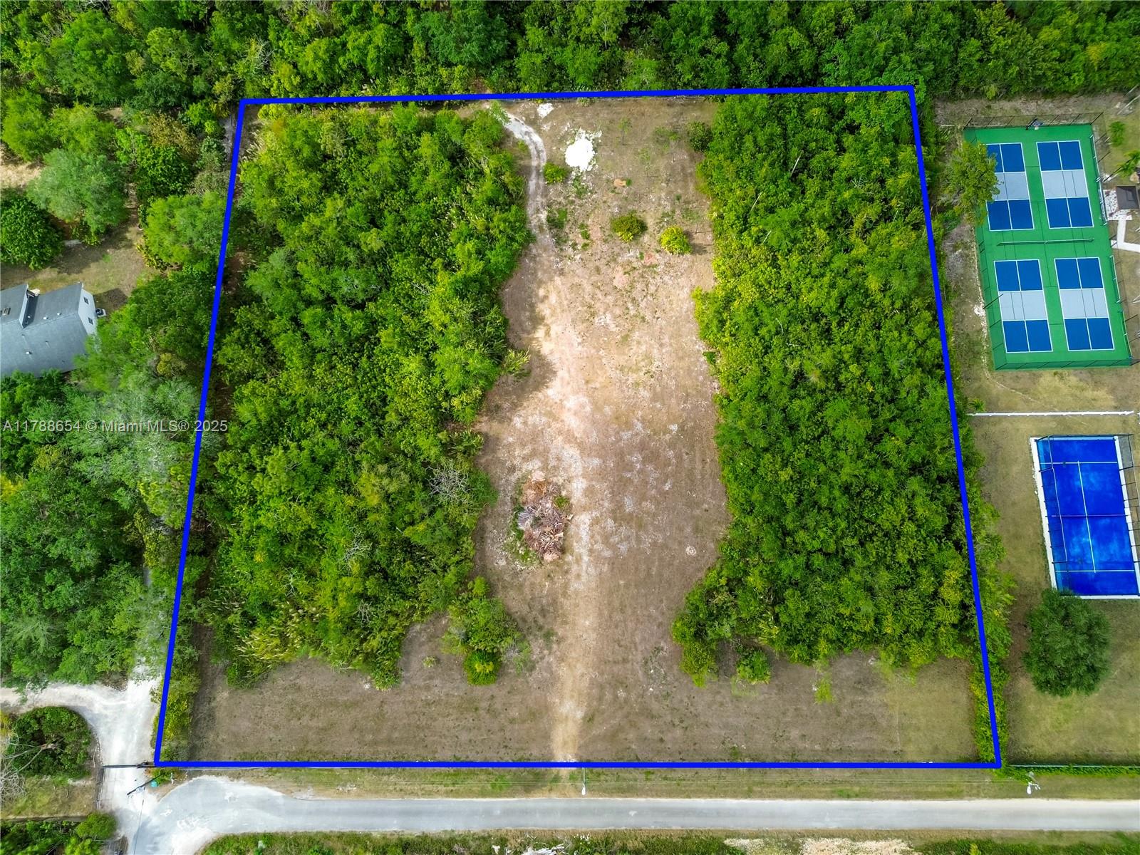 Rare opportunity to own 2.237 acres in Miami-Dade’s AU-9000 agricultural zone. This fully fenced lot features gated access on the south side and offers privacy and flexibility for rural living or agricultural use. Approximately 2.0 acres are designated as Natural Forest Community, preserving native vegetation and supporting a peaceful, eco-friendly lifestyle. No utilities on site; electric is available at the street. No well or water connection currently available. Ideal for building a custom home or enjoying as a private recreational retreat. Surrounded by nature, yet within reach of Miami-Dade conveniences, this land is perfect for those seeking space, seclusion, and potential.