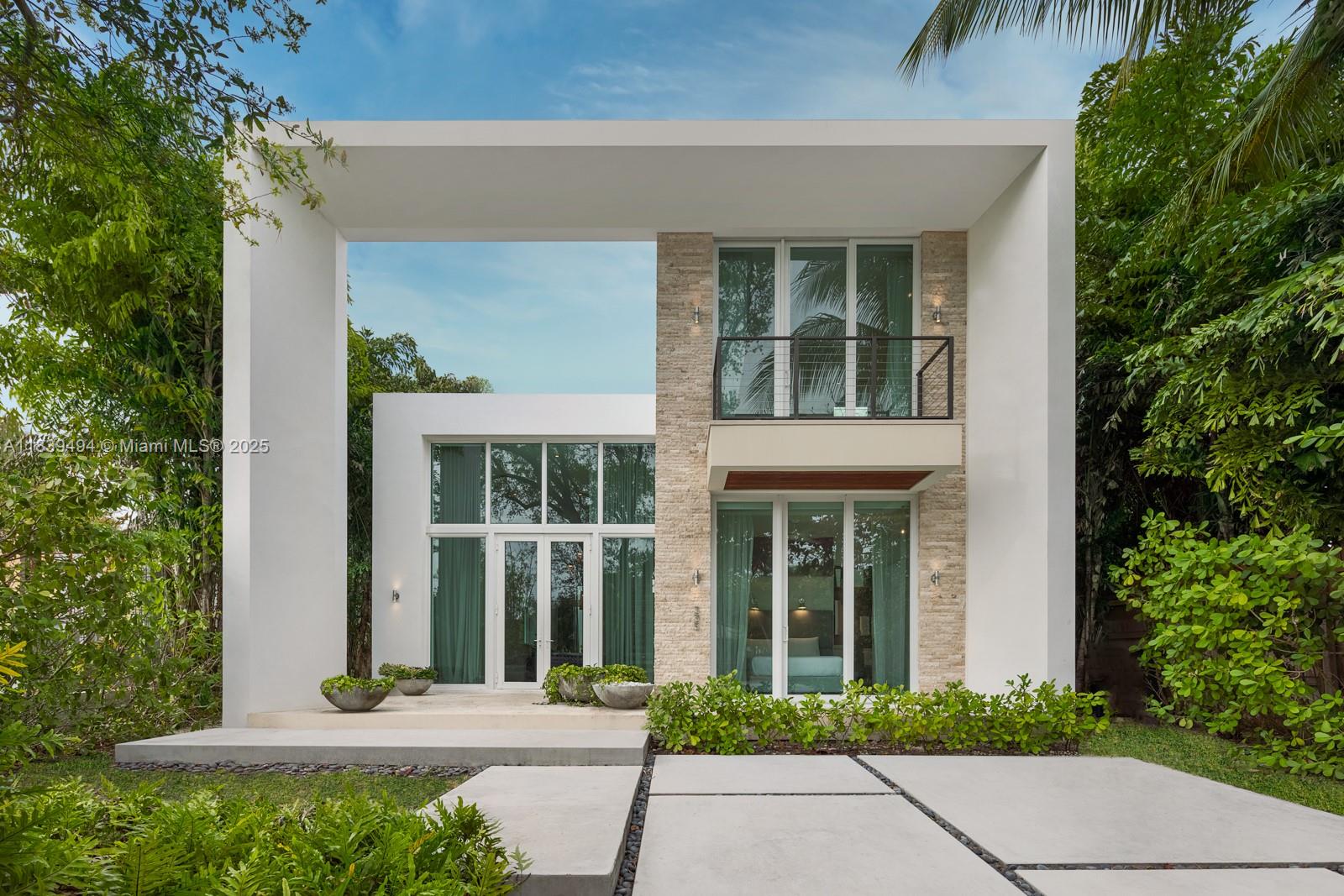 This sleek two-story modern home features 4 spacious bedrooms, 4.5 baths, and 3,280 SF of refined living space on a 7,500 SF lot. Located in the heart of Miami Beach, this gated residence offers privacy and peace on a quiet, low-traffic street. Highlights include a heated pool, marble-accented master bath with freestanding tub, soaring double-height ceilings, and two laundry rooms for added convenience. Built by Todd Michael Glaser, this turnkey home blends luxury, style, and sophistication, all within close reach of the best Miami Beach has to offer.