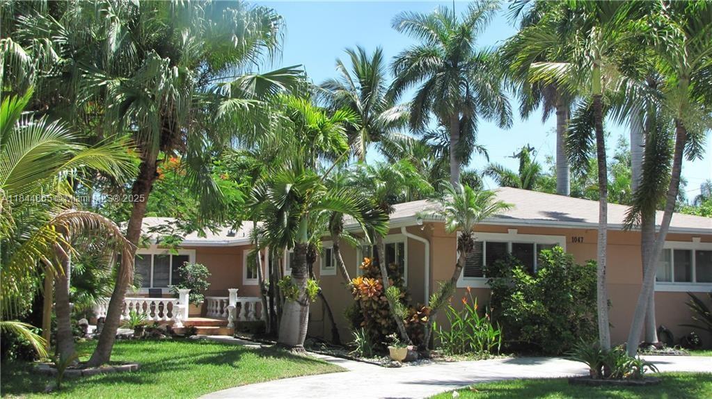 Fantastic location! This bright, spacious 4-bedroom, 2-bath POOL home offers over 2,700 sq ft of living space, an oversized lot, and a full 2 car garage. Enjoy a beautifully updated kitchen with granite counters, updated bathrooms, generously sized bedrooms, elegant crown moldings, formal dining area, and an oversized Florida room overlooking the beautiful pool. The backyard is built for entertaining with a covered tiki hut, wet bar, and a swim-out pool surrounded by lush, private landscaping. Impact windows and doors, a circular driveway, additional parking in the back, and a fenced yard add comfort and convenience. A true retreat with room to relax, entertain, and feel right at home. Gas utilities (double oven is electric) & home is equipped with a gas generator for extra peace of mind!