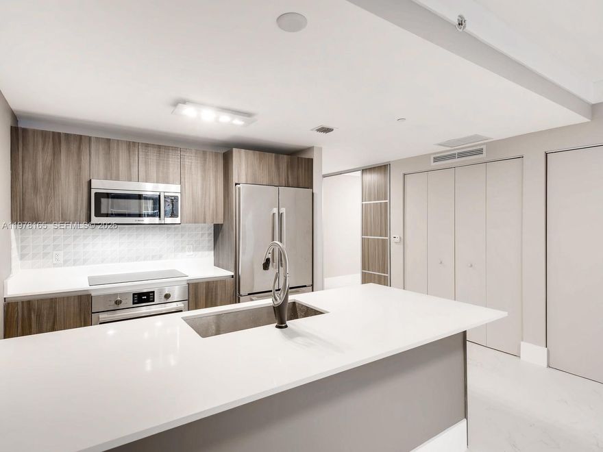 Searching for a condo in Edgewater Miami with bay and city views? This residence at Aria on the Bay offers bright open living spaces, a versatile den ideal for a home office or guest area, and a spacious balcony overlooking Biscayne Bay.

Experience elevated waterfront living in the heart of Edgewater at the sought-after Aria on the Bay. This bright and modern residence features an open layout designed for both everyday comfort and effortless entertaining. Floor-to-ceiling windows bring in natural light while the expansive private balcony offers north-facing views of Biscayne Bay and the Miami skyline, creating the perfect setting to relax and enjoy the city’s energy.

The thoughtfully designed floor plan includes a spacious living and dining area that flows seamlessly into the contemporary kitchen with sleek cabinetry and stainless appliances. A versatile den adds valuable flexibility, ideal for a home office, media room, or guest space. The primary suite offers generous closet space and a well-appointed bathroom, while the additional bathroom provides convenience for visitors.

Residents enjoy an impressive collection of resort-style amenities including sunrise and sunset pools overlooking Biscayne Bay, a state-of-the-art fitness center, yoga studio, spa facilities, theater and entertainment rooms, social lounges with billiards, business center, outdoor BBQ areas with summer kitchens and concierge service. Rented to a wonderful tenant till Nov 2026 for $3300/m.