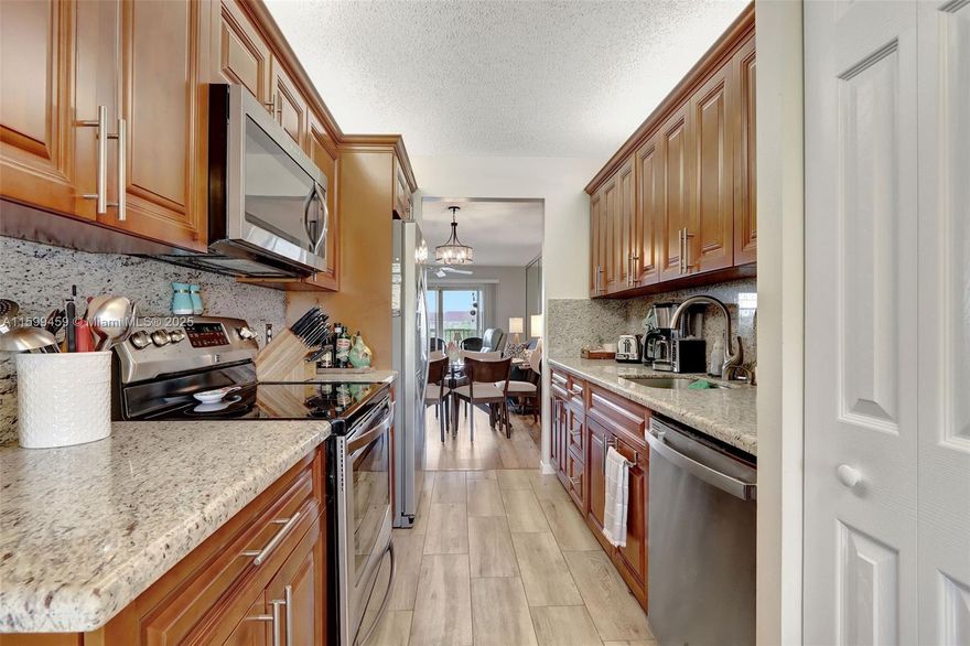 Stunning Lakefront 2 Bed, 2 Bath Condo in Century Village, Pembroke Pines (55+ Community). This elegant unit boasts a remodeled kitchen with SS appliances and granite countertops, upgraded bathroom vanities, and waterproof vinyl flooring throughout. Enjoy in-unit laundry, accordion shutters on all windows, and an impact sliding door leading to a balcony with serene lake view. Assigned parking included. Resort-style amenities: multiple pools, clubhouse, tennis courts, billiards, theater, golf course, shuttle bus services, fitness room, and more! No rentals allowed in the first 2 years of ownership. It's the condo you've been waiting for - Call/text Listing Agent today for your appointment!!