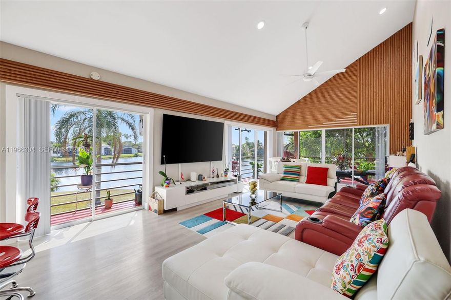 Welcome to The Atrium, a Woodmont community. This spacious second-floor 3 bedroom, 2 bathroom corner unit is move-in ready! As you enter your foyer area, you're greeted with an open concept layout with super high ceilings in the main living areas with tons of natural light pouring in from multiple sliding doors. Enjoy the breathtaking lake views right from your living room that makes it feel like you're on the intercoastal. Enjoy the expansive wrap-around balcony area perfect for indoor/outdoor living. Kitchen features beautiful white cabinetry, quartz countertops, SS appliances, complimentary backsplash, pantry, and a cooking island perfect for bar-style seating. Waterproof vinyl flooring throughout. Primary bedroom features a nice-sized walk-in closet, sliding doors to the balcony, and a sleek primary bathroom with dual sinks and a nicely updated frameless shower. Full sized laundry room added for convenience. Accordian shutters throughout for peace of mind. Newer AC unit last installed in 2021. A desirable split floorplan with a generous sized storage closets. Two assigned parking spaces with tons of guest parking. Maintenance includes water/sewer, trash, roof repairs, lawn/landscaping, community pool, & more. The Woodmont community has gold course memberships and is centrally located by supermarkets, parks, schools, dining, highways, and so much more! Schedule your showing today!