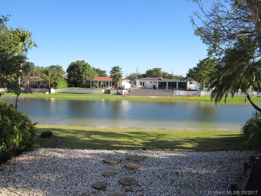 One of a kind Miami Springs lake house. Located on a quiet cul de sac street on the largest lake in the Springs. This split plan 4 bedroom 2 bath property features carpeting and wood floors, indirect recessed lighting, custom built-in cabinets, and a vaulted ceiling in the oversized living room that opens into the family room. Enjoy the serene lake view from most all rooms. The kitchen has granite counter tops and a new stainless steel refrigerator. The master bath has been updated with a new shower and vanity. The house features a rear wood deck, metal roof, some hurricane impact resistant windows, attached 1 car garage and a circular driveway. Walking distance to Springview Elementary and Miami Springs High schools.