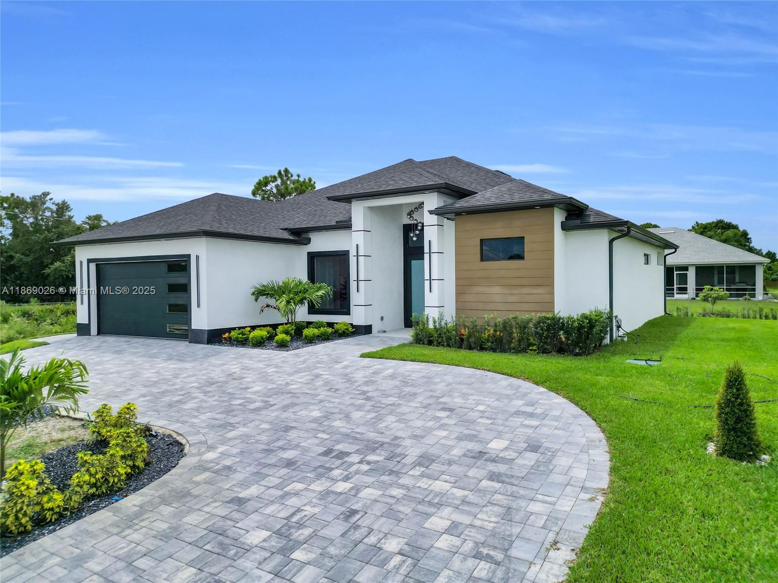 STUNNING NEW MODERN HOME!!! Elegance, comfort, and modern design. Four beds, three baths, two-car garage. The gourmet kitchen showcases modern appliances, including a built-in oven and seamlessly integrated cooktop ser into the custom cabinets and quartz countertops. Beautiful porcelain floors and a garage epoxy finish. Enjoy an exceptional lifestyle with built-in speakers perfect for entertaining, and you will find a fabulous outdoor kitchen complete with a wine cooler. This home also boasts a spacious circular paver driveway. The best locations in Lehigh Acres, close to schools, shops, restaurants, and entertainment. Make your offer today!!!