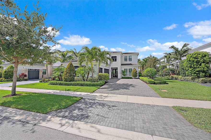 Perfectly situated in the center of Artistry, this home offers a peaceful water view and desirable southern exposure, filling the interior with natural light throughout the day. With an easement between you and the next-door neighbor, you'll enjoy a greater sense of privacy and space, rarely found in this community. Inside, tasteful upgrades and designer finishes create a polished yet comfortable atmosphere. White oak flooring, quartz surfaces, beautiful crown molding, and upscale fixtures are featured throughout. A versatile front room sets the stage for entertaining or formal gatherings, while the chef's kitchen delivers top-tier performance with GE Monogram appliances, a 6-burner gas range with griddle, three ovens, an oversized waterfall island, wine cooler, and upgraded cabinetry.