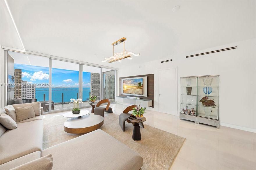 SIGNIFICANT PRICE IMPROVEMENT — Exceptional Value. The owner has acquired another residence in the building, creating a rare chance to secure a generously proportioned Aston Martin home offered at the lowest price per square foot for a residence of its kind. This expansive 3,075 SF flow-through home at the Aston Martin Residences represents a compelling opportunity to acquire a residence that boasts panoramic views of Biscayne Bay and the City Skyline.  This residence features three bedrooms, four-and-a-half baths, plus a convertible den/media room.  The distinct floor plan includes an enlarged primary suite and guest bedroom, offering enhanced comfort and functionality. Additional highlights include staff quarters with en-suite bath and laundry area, seamless indoor-outdoor living with a generous terrace, and TWO ASSIGNED PARKING SPACES—a highly coveted feature within the building.
The interiors feature marble floors and Gaggenau appliances. It is fully furnished, with built-in closets, motorized window treatments throughout, specialty lighting, audio visual equipment and 6 T.V’s. Enjoy exclusive access to over 42,000 Sq. Ft. of impressive world-class amenities, considered among the best in Miami, including: Indoor and outdoor swimming pools, Two-story state-of-the-art fitness center; Full-service spa; Golf simulator; Art gallery; Screen room, Conference room, Meeting rooms, Children’s lounge; and much more.