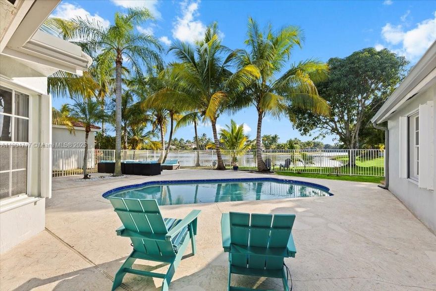 This beautifully updated resort style single-family waterfront home has it all, including solar panels and substantially reduced FPL bill. It features a modern kitchen, 5 bedrooms, 2.5 baths, 2 car garage, 2600+ sq ft. living area, 4 high end wall mounted flat screen TVs and more.  The backyard features a heated SALT water pool, Argentinian BBQ built-in grill, waterproof sectional sofa, Adirondack chairs, fruit trees and breathtaking lake view.  The spacious split floor plan layout is well suited for a growing family.  Landscaping and pool maintenance are included.  A rated public school system.  All information herein is deemed accurate but not guaranteed.