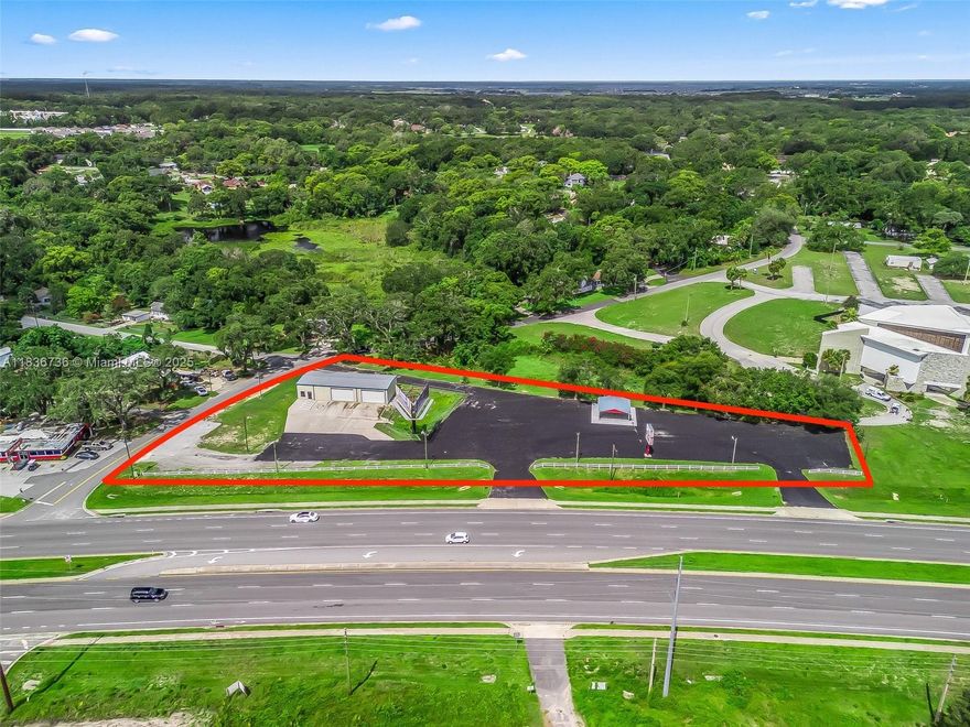 Prime commercial opportunity double lot with OWNER FINANCING AVAILABLE in the heart of Fruitland Park! This versatile property at 301 Beam Street features an established automotive garage with multiple bays, overhead doors, and ample workspace ideal for mechanics, auto repair, or service-related businesses. Also has 60,000 square feet of paved asphalt/parking. Its excellent visibility and convenient access from major roads with zoning and layout that can accommodate a variety of uses, from retail stores and restaurants to warehouses and office space, this site offers exceptional flexibility for an owner-operator or investor. The property also includes a billboard that currently generates approximately $20,000 yearly in income.