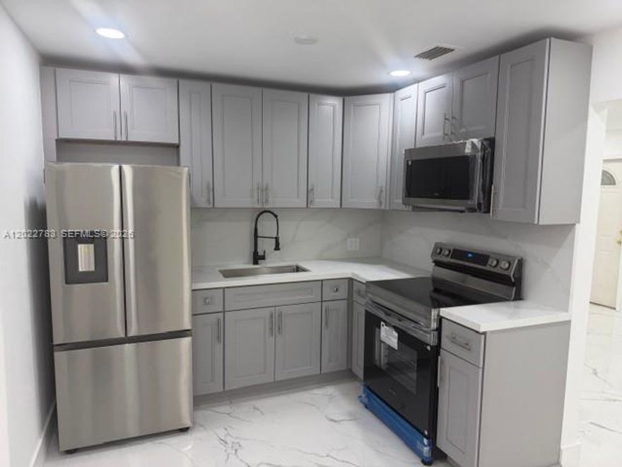 Beautiful Move-In Ready 3 Bedroom, 2 Bathroom Home featuring modern upgrades and an ideal central location! This well-maintained property offers a brand-new kitchen with stylish cabinetry, quartz countertops, and new appliances. Recently renovated bathrooms add a fresh and modern touch throughout the home.

Enjoy large marbleized tile flooring throughout the kitchen, dining, and living areas, along with vinyl flooring in all bedrooms for comfort and durability. The spacious backyard offers plenty of room to build a pool, entertain, or create your own outdoor oasis.

This home also features two front entrances with ample parking space and is conveniently located near shopping centers, restaurants, schools, and major highways for easy commuting.

 the owner will be installing BRAND NEW IMPACT WINDOWS — perfect for added protection and peace of mind during hurricane season!