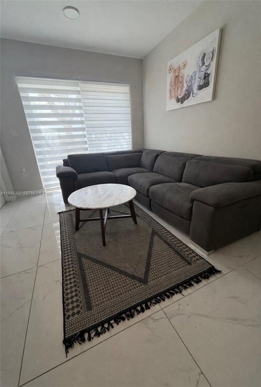 Beautiful townhouse featuring 4 bedrooms and 3.5 bathrooms. Built in 2022 with a solid concrete structure, impact windows and doors, and porcelain tile throughout. Modern open kitchen with stainless steel appliances, quartz countertops, and wood cabinetry.
The first floor includes a spacious owner’s suite with a built-in walk-in closet. The second floor offers additional bedrooms, including a primary suite, along with washer and dryer included. Additional features include a tankless water heater and private balcony.
Enjoy a large rooftop terrace with open sky views—perfect for outdoor living, entertaining, and relaxing. Conveniently located with easy access to the Turnpike and US-1. Builder warranty included. Low HOA fees.