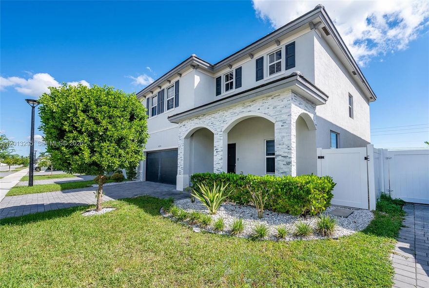 Beautifully maintained two-story home offering 4 bedrooms and 3.5 baths, featuring modern finishes and an exceptional outdoor living space. The bright, open-concept layout includes a spacious living area with soaring ceilings, updated lighting, and neutral tile flooring throughout the main living spaces. The contemporary kitchen boasts white cabinetry, stainless steel appliances, ample counter space, and a large island ideal for entertaining. Step outside to a covered patio with ceiling fans, a custom paver patio, and a fully fenced backyard—perfect for gatherings or relaxing in privacy. Upstairs features generously sized bedrooms, updated bathrooms, and a spacious primary suite with a walk-in closet and spa-like bath. Additional highlights include a two-car garage, paver driveway, and lush landscaping. Conveniently located near shopping, dining, and major roadways. Move-in ready and a must-see!