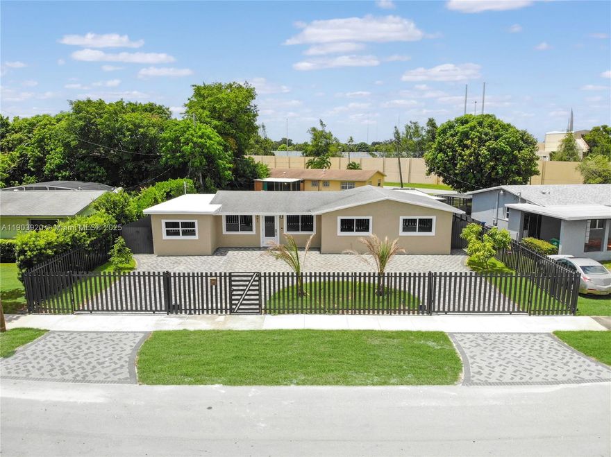 Stunning 4-bed, 3-bath home in the heart of Miami Gardens featuring modern upgrades and a resort-style backyard! The home offers a sleek kitchen with stainless steel appliances, porcelain tile floors, and ambient lighting.  Cabana pool bathroom for added flexibility. The backyard is built to entertain—enjoy a covered patio, custom lighting, turf area, and a sparkling pool. Fully fenced with motorized gate, oversized paver driveway, and plenty of parking. Centrally located just minutes from Hard Rock Stadium, Topgolf, Calder Casino, major highways, schools, and shopping centers. This move-in ready home blends comfort, style, and convenience—perfect for large families.