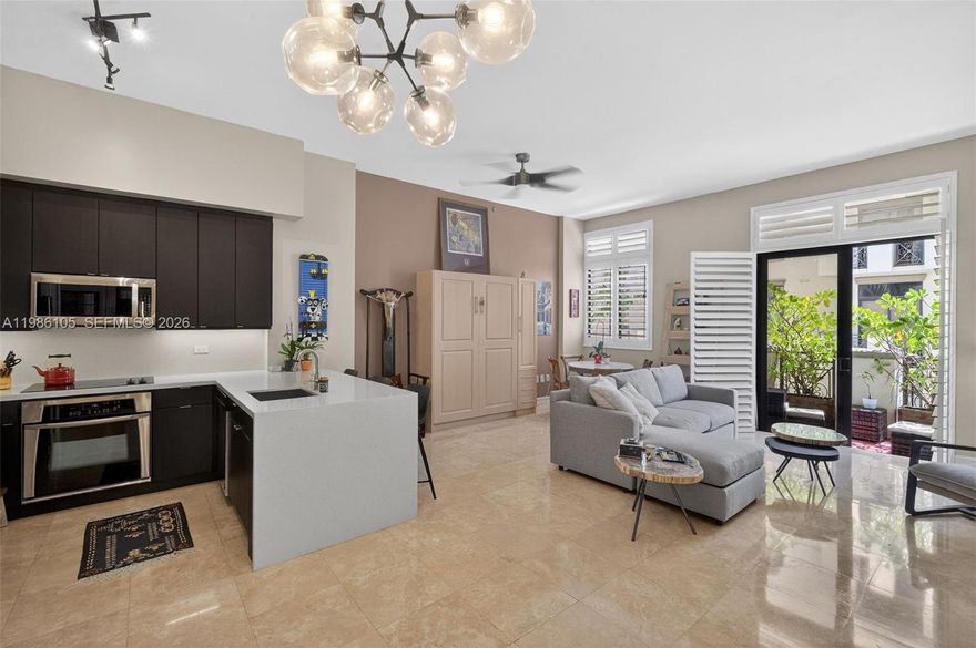 Beautifully located in the heart of Coral Gables, largest 1-bedroom residence at Ponce Tower offers bright, open living with soaring 11 ft. ceilings, travertine marble floors, updated lighting, and real wood shutters throughout. The European-style kitchen features quartz countertops, premium appliances, and a spacious island with seating. The generous bedroom includes a walk-in closet, while a Murphy bed adds flexibility for guests. A Jack-and-Jill bathroom is ideal for hosting. Enjoy a private balcony overlooking the peaceful courtyard pool. Full-service building with 24-hour concierge, resort-style pool & spa, fitness center, and more—just minutes from Downtown, Brickell, and the beaches.