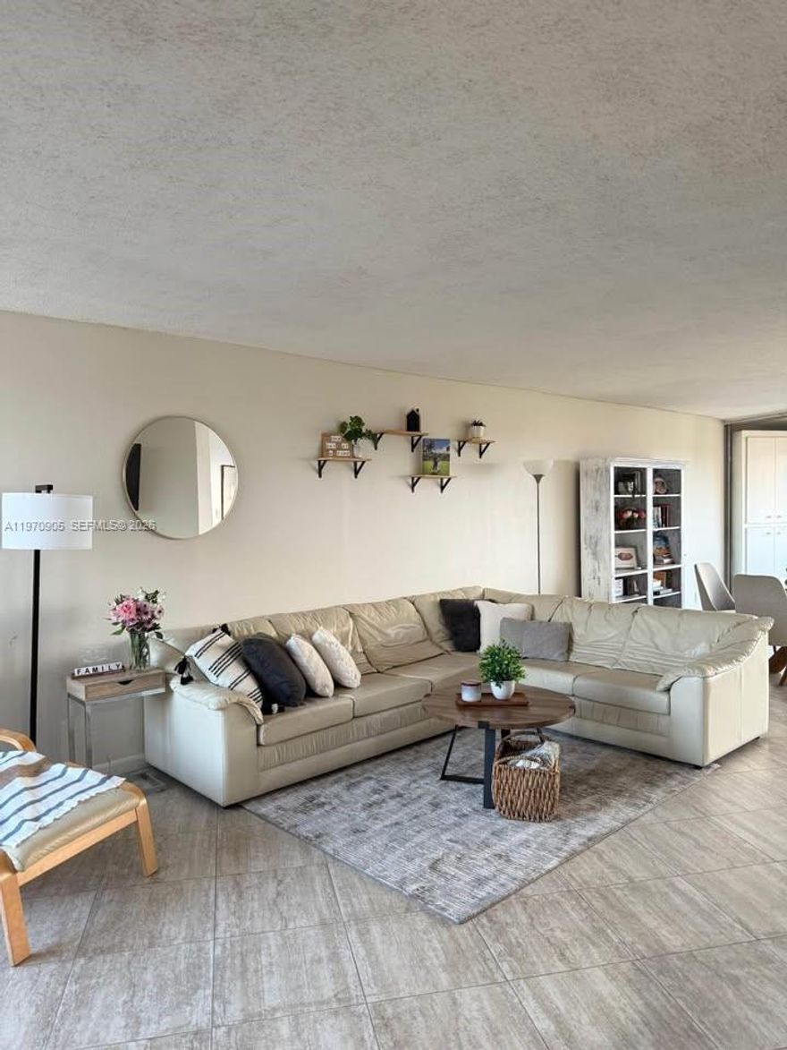 Impeccably maintained penthouse with breathtaking, clear, unobstructed panoramic views from your spacious private balcony perfect for sunrise and sunset. This top-floor residence offers 1,160 sq ft of  living space filled with natural light. Include a beautifully renovated kitchen and bathroom, modern finishes, and ample storage. Resort-style amenities: pool, fitness center, bowling alley, pickleball, and tennis courts. Includes one covered parking space with direct elevator access, additional outdoor space, and guest parking.Two spacious bedrooms featuring California-style walk-in closets and two full bathrooms. Maintenance includes water, internet, and cable, with premim channels providing exceptional value and convenience. New kitchen and bathroom.Security guard on site with 24-hour security and lobby intercom access. Ideal for a safe, secure, and comfortable lifestyle.