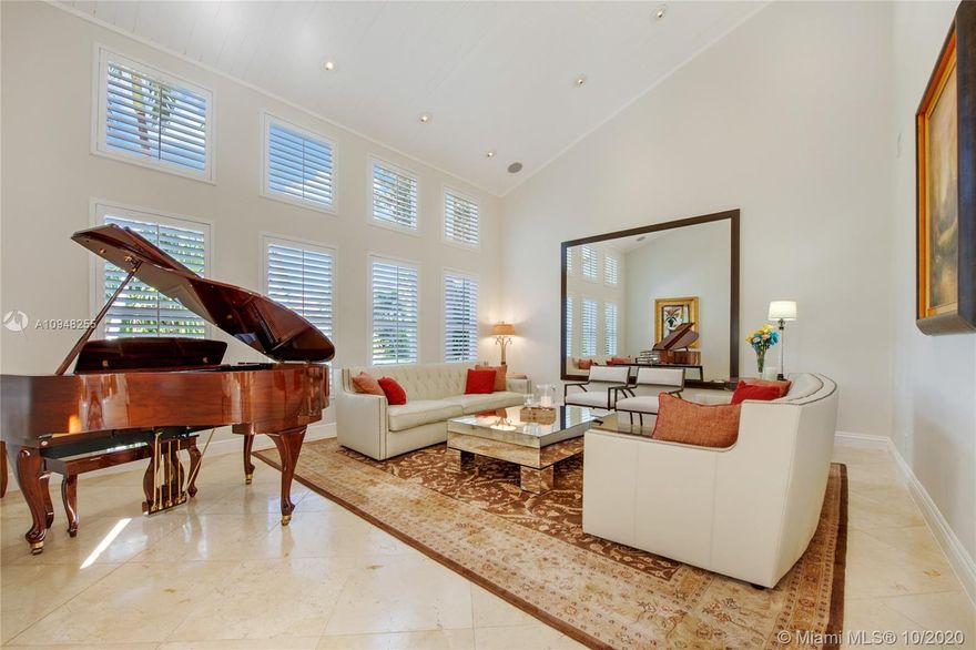 Waterfront w/wide lagoon view 2 story Contemp centered around beautiful atrium. Frml LV/DRM.Kitchen open to fmly rm w/fireplace overlooks water, granite tops & wood cabinetry. Fmly rm & guest bthrm.1st flr 1 bdrm w/bth & walk in closet 1 bdrm w/bath, Maid's rm, laundry rm, 3 car garage. Upstairs Lg. master, walkin closets, beautiful master bath. Plus 2 bedrooms each one with a bath. Impact windows/shutters, generator, Lutron system. Covered terrace w/views of water, large heated pool w auto salinization system, 65ft dock & davits. New Roof in 2011.