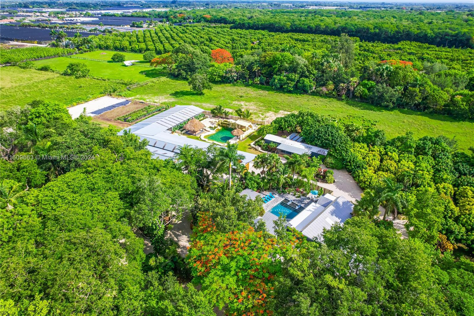 One of a kind 5-acre organic compound in Redland built to last generations. This is a spiritual place where you are one with nature. You are on vacation. This property speaks for itself. Please enlarge all photos to review remarks. Highlights are: A canopy of hardwoods lushly landscaped with multiple living areas, courtyards w/ dining & sitting areas, custom pool, grotto w/ waterfall, many appliances new & under warranty. A 10,000 sq.ft outbuilding features an air-conditioned office, game room/gym w/ AC, baths, walk in cooler, CBS secured garage, ability to open & close off area as needed. Meandering drivable pathways allow easy through the irrigated grounds, a natural pond w/ fish, grove, organic garden, plus. Low taxes w/ no restrictions. Furniture & Business negotiable.