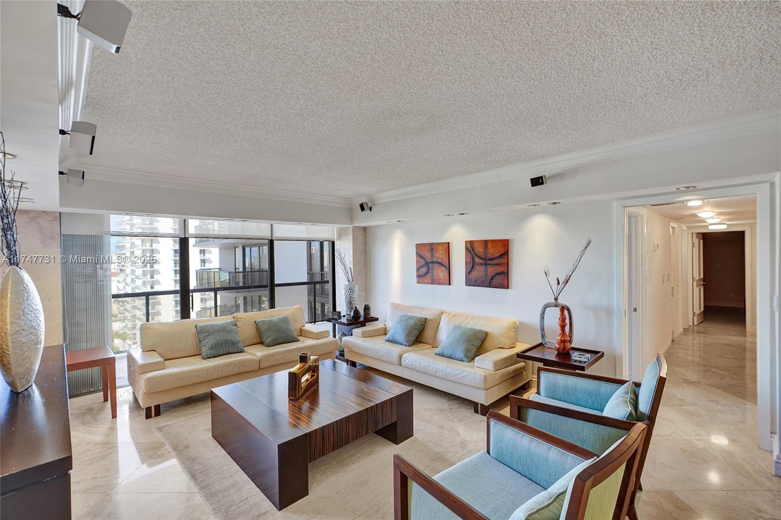 Reduced! Experience luxury living in this stunning 2-bed, 2-bath condo with a den in Aventura! Flooded with natural light, all bedrooms open to a spacious balcony with serene marina and city views. The open kitchen boasts Bosch stainless steel appliances, granite countertops, and a stylish backsplash. Enjoy marble floors in social areas, custom closets, and in-unit washer/dryer. The master bath features double sinks and a separate tub. Accordion hurricane shutters provide peace of mind. Resort-style amenities include a pool, gym, tennis courts, party rooms, valet, and 24/7 security. Assessment paid!