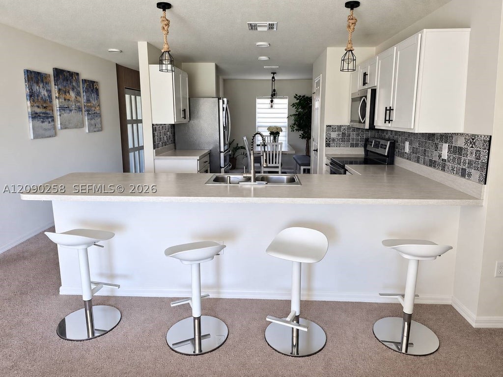 Photo of 830 SW Durham Ter #1, Port St Lucie, FL 34953 (MLS # A12090258)
