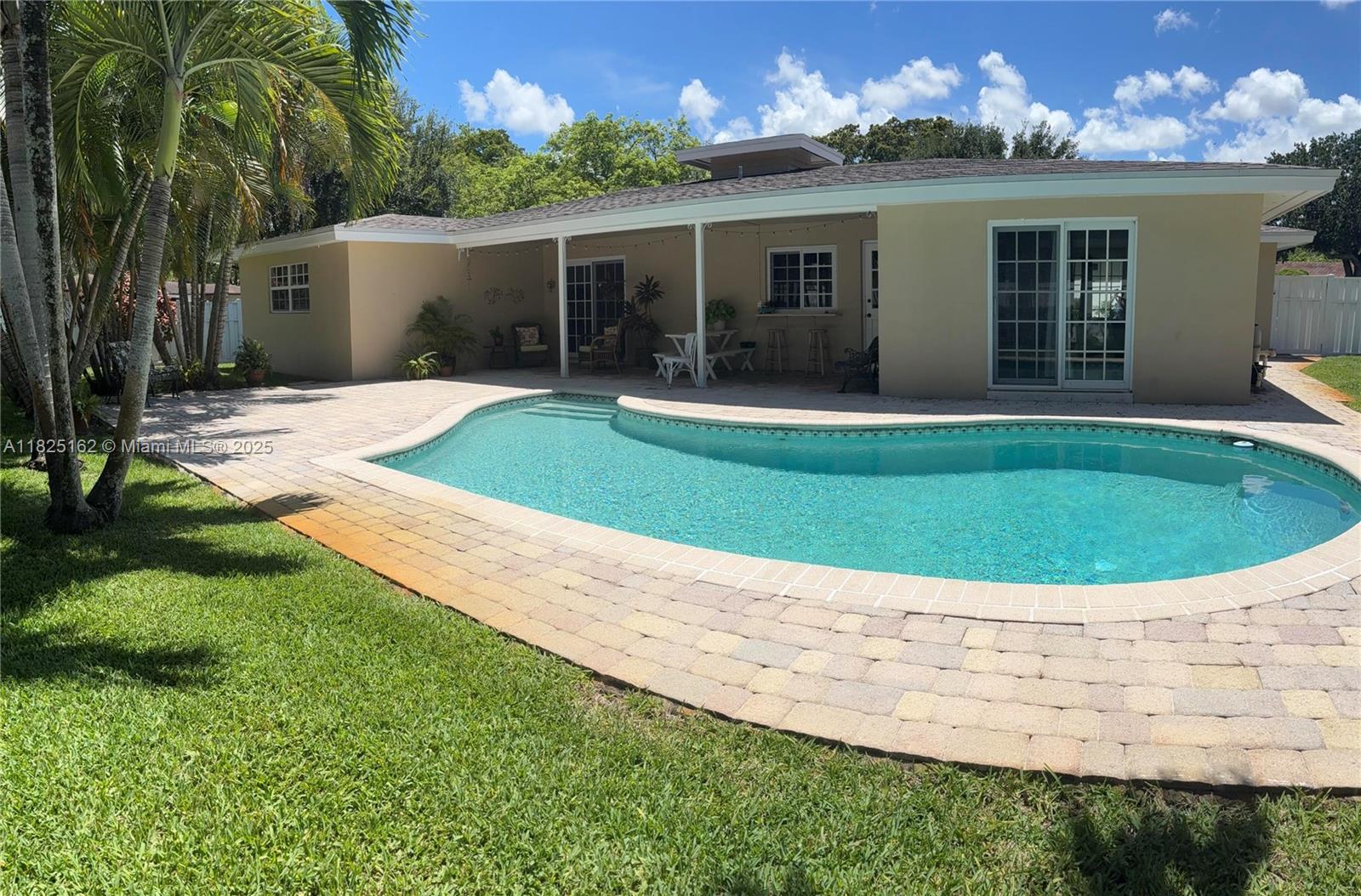 Spacious 4 bedroom 3 bathroom home on a huge corner lot.
Enjoy the pool, patio and lanai surrounded by lush tropical landscaping and a beautiful lawn.
It has an island kitchen with a pass-through window to the patio bar, impact windows, a roomy two car garage, a new roof, a new water heater and a new electric panel and breakers. One of the primary bedrooms has a walk-in closet and the other primary bedroom has sliding glass impact doors overlooking the pool. There is a shed with electric and a sprinkler system.
This home is full of light, with large picture windows across the front and sliding glass impact doors in the back, overlooking the pool. The kitchen is right off the patio, which makes it perfect for entertaining with family and friends-- and there's plenty of parking.