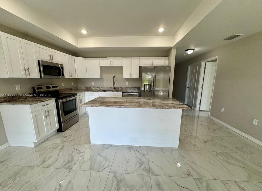 Welcome to this stunning 3-bedroom, 2-bathroom duplex, offering 1,150 sq. ft of modern living space designed for comfort and style. Step inside to an open-concept layout featuring gleaming marble-inspired tile floors that flow seamlessly from the spacious living area to the gourmet kitchen. The kitchen boasts white shaker cabinets, elegant quartz countertops with a beautiful veining pattern, stainless steel appliances including a range, microwave, dishwasher, and refrigerator, plus a convenient island perfect for casual dining or entertaining. Practical amenities include an in-unit washer and dryer, as well as an attached garage for secure parking and storage.

This move-in-ready duplex combines functionality with upscale touches—schedule your showing today!