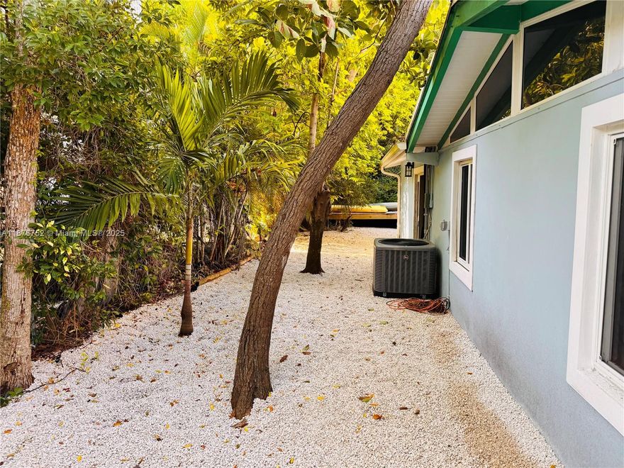 Charming 3-bed, 2-bath Conch home just 2 blocks from the HOA boat ramp! This ground-level home blends classic Florida Keys style with modern updates, including a 2018 kitchen and updated bathrooms. Featuring original Dade County pine ceilings, the property sits on a 60x100 lot with low-maintenance P rock landscaping. The cleared side yard is perfect for boat parking, making it easy to launch at Pirates Cove HOA ramp. The private backyard, with key lime and mango trees, offers a tropical retreat. Enjoy boating, fishing, and beach days in one of Key Largo's top neighborhoods—without the waterfront price! Don't miss this affordable, comfortable gem!