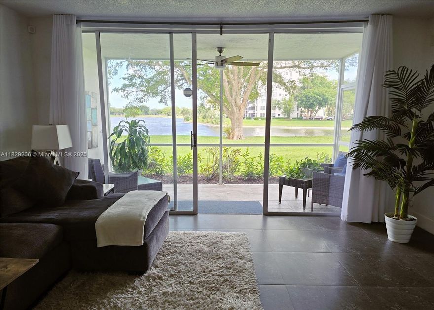 Spacious 3/2 First-Floor Corner Unit with Lake Views! Bright and airy condo in a 2-story building featuring impact windows, tile floors throughout, and modern accents. Corner unit provides an abundance of natural light. Enjoy stunning lake views from the screened-in patio. 3 spacious bedrooms with ample closet space, and 2 full baths. Enjoy the convenience of an in-unit washer and dryer and assigned parking directly in front of the unit. Maintenance covers cable, internet, water, outside maintenance, security patrol, and use of Association pools. No leasing for the first year of ownership. Prime location just minutes from major highways, shopping, dining, and the beach. Don't miss this one! A perfect place to call home!