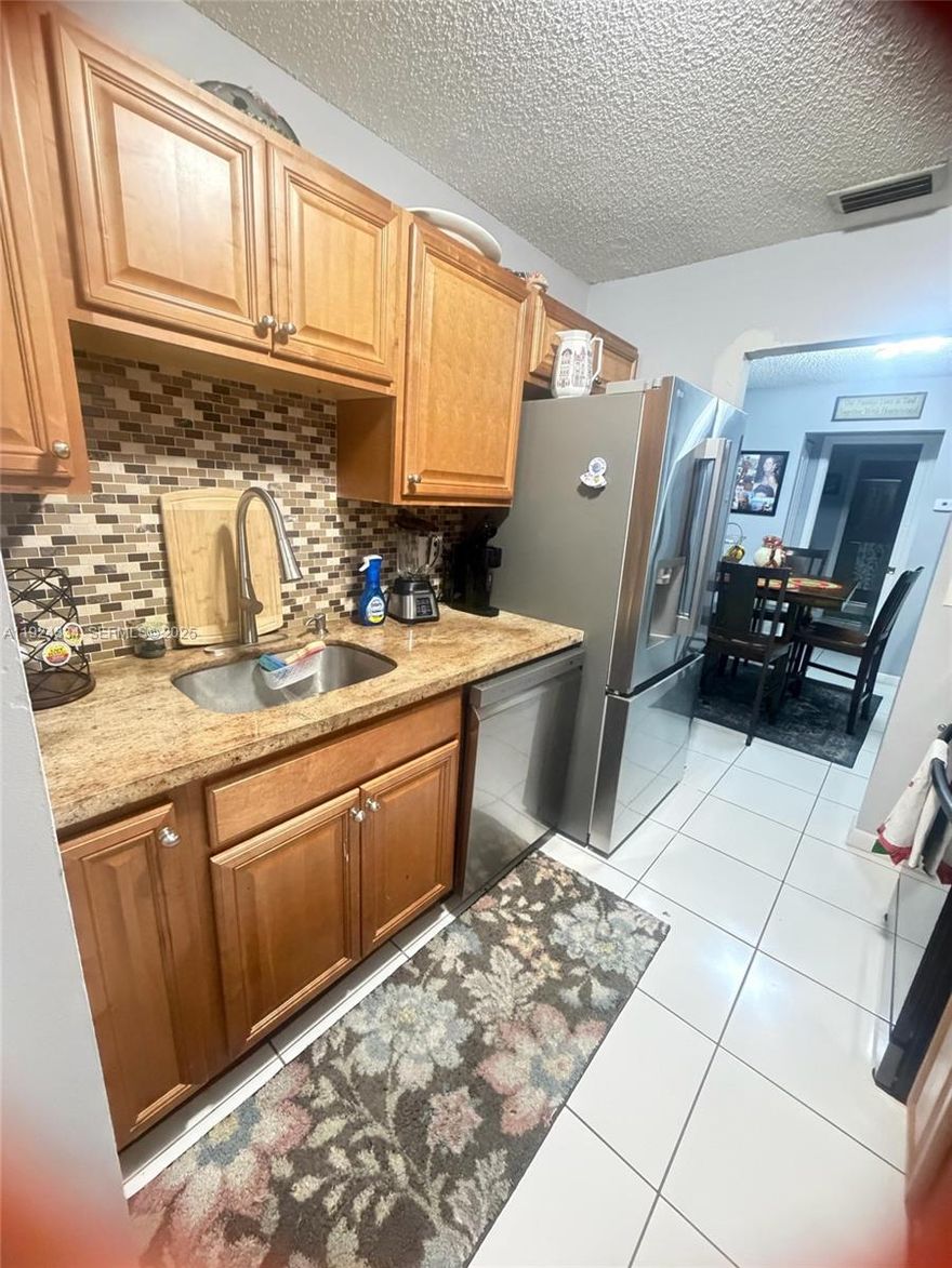 Beautifully updated 1 bedroom villa with 1 1/2 baths, featuring high- end, brand new appliances, tile throughout and washer and dryer inside. This villa offers a private fenced backyard, two assigned parking spaces and access to a community pool. Recently remodeled move-in ready.