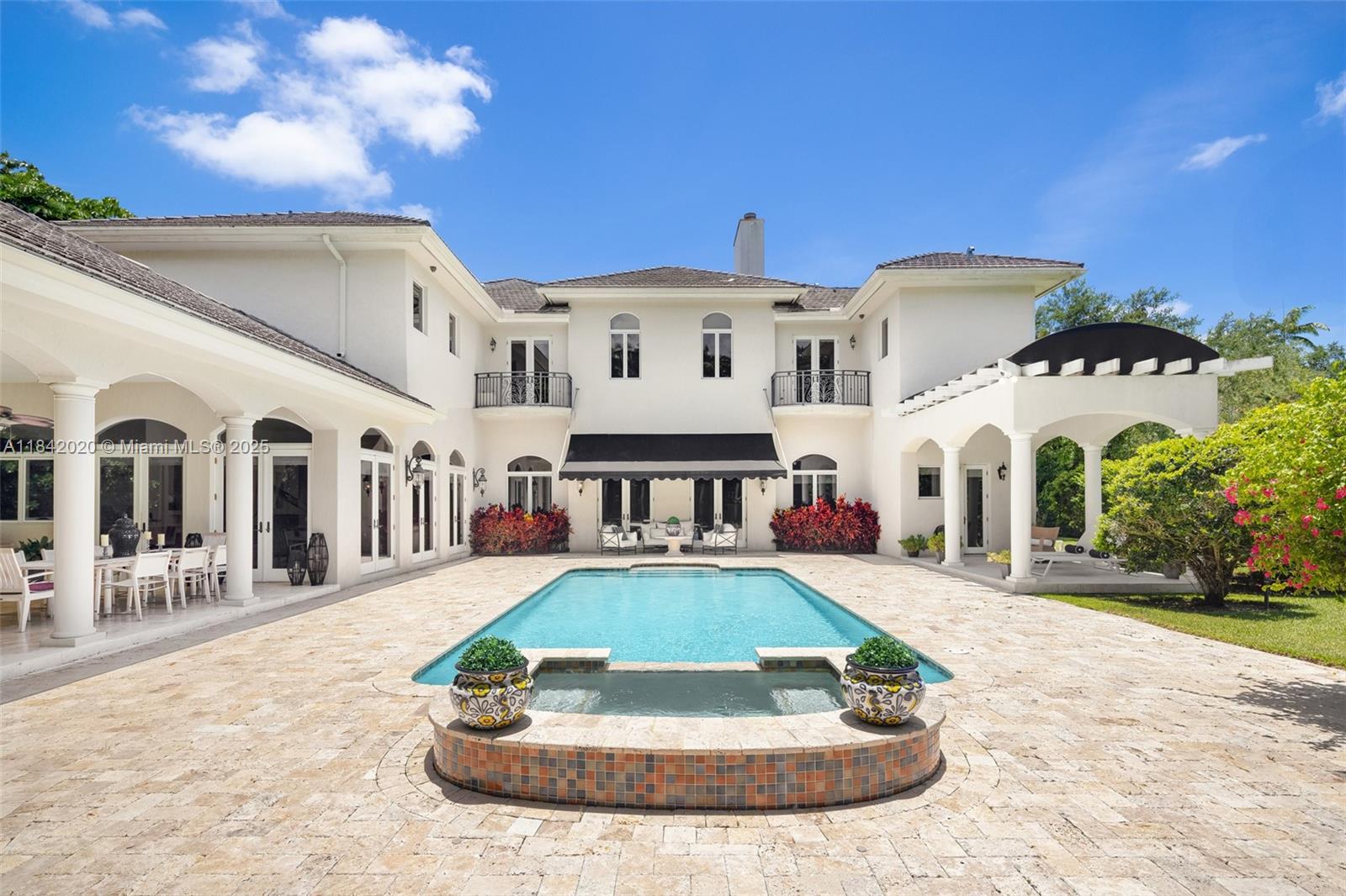 Nestled in the exclusive Ponce-Davis neighborhood, this timeless French-inspired estate offers a blend of classic elegance and refined comfort. Set on over 51,000 square feet of lush, gated grounds, the home was crafted by Palmira Homes and features expansive living spaces designed for gracious living and effortless entertaining. A stately foyer opens to a formal salon, library, media room, and a gourmet kitchen with full catering pantry. Outdoors, a summer kitchen, and a resort-style pool create a tranquil escape surrounded by manicured gardens. A four-car garage and elevator complete this exceptional offering. Located on one of Miami’s most coveted streets, just minutes from top schools and the best of Coral Gables. A true legacy property in one of the city's most prestigious enclaves.