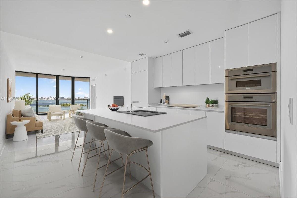 Experience elevated coastal living in this 3-bedroom + den sky residence at Miami’s newest luxury landmark. Enjoy a private foyer, expansive layout, and floor-to-ceiling glass showcasing unobstructed bay and skyline views. Designed for those who crave space, style, and serenity with world-class amenities and waterfront elegance. All in the heart of it all, just minutes from the Design District, Midtown, Downtown, the beach, and everything Miami has to offer!