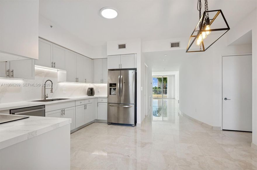 This bright and spacious 2-bedroom, 2-bathroom apartment is located at The Ocean Club in Key Biscayne. Upon taking the elevator, you'll arrive at your own private entrance, leading you into a generously sized living room with an eastward orientation, providing views of the lake and the tennis center. The apartment features Brand new Kitchen with quartz countertops, and stainless-steel appliances, marble floors in the living areas and wood floors in the bedrooms, creating an elegant contrast. The Ocean Club offers a resort-style living experience, multiple pools, restaurants, a tennis club, a gym, a children's play area, basketball facilities, Padel Courts and access to the beach.