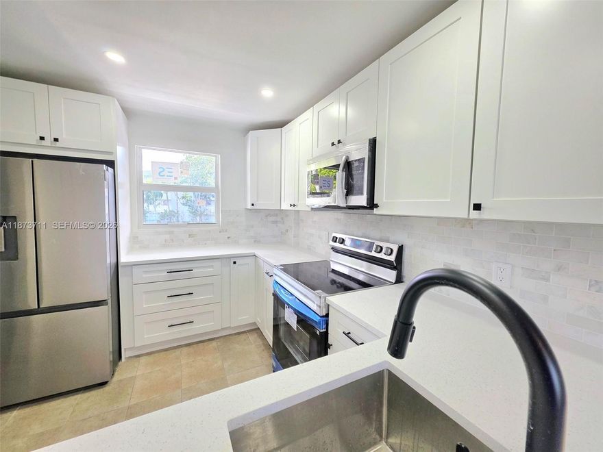 Owner Financing Available!!  Beautiful Renovated 2 Bedroom-2 Bathroom Condo in a Very Pet Friendly Community with Water Views - Brand New Impact Windows and Sliding Glass Doors - Brand New Kitchen with Shaker Style Cabinets, Stainless Steel Appliances, and Quartz Counter Tops - Brand New Bathrooms - Brand New Baseboards -  Walk-in Closets - Brand New Closet Organizers - Guard Gated Community - Walking Distance to: Royal Palm Park, Stunson Nature Trail, and Oakland Bark (Dog Park) - 5 Minutes from I95 and 15 Minutes from the Beach