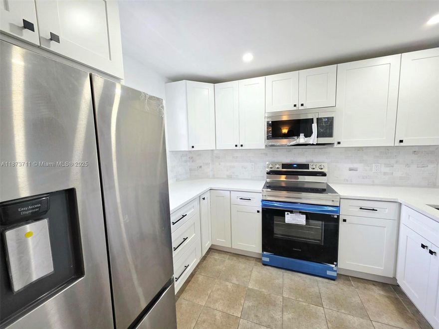 Owner Financing Available!!  Beautiful Renovated 2 Bedroom-2 Bathroom Condo in a Very Pet Friendly Community with Water Views - Brand New Impact Windows and Sliding Glass Doors - Brand New Kitchen with Shaker Style Cabinets, Stainless Steel Appliances, and Quartz Counter Tops - Brand New Bathrooms - Brand New Baseboards -  Walk-in Closets - Brand New Closet Organizers - Guard Gated Community - Walking Distance to: Royal Palm Park, Stunson Nature Trail, and Oakland Bark (Dog Park) - 5 Minutes from I95 and 15 Minutes from the Beach