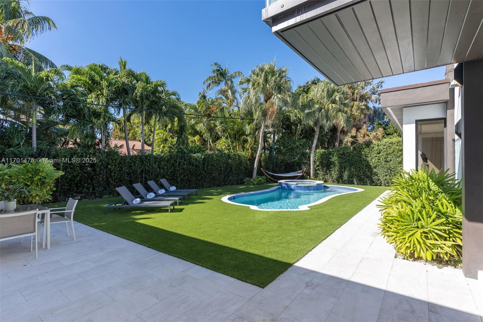 This fully renovated 5-bedroom, 5.5-bath, 4,500 sq ft home blends modern elegance and functionality. Ideal for entertaining or large families, it features an open-concept layout with porcelain tile floors throughout the first floor and warm ash wood in the upstairs primary suite. The ultimate chef’s kitchen boasts quartz countertops, dual sinks, and GE Monogram appliances, including TWO 36” refrigerators/freezers, gas/electric range, and dual dishwashers. Skylights fill the home with natural light, and a microcement accent wall highlights the foyer. The backyard oasis includes a heated saltwater pool, hot tub, and astroturf landscaping. Smart features: Ring doorbell, outdoor cameras, Lutron lighting, and Wi-Fi-controlled systems.