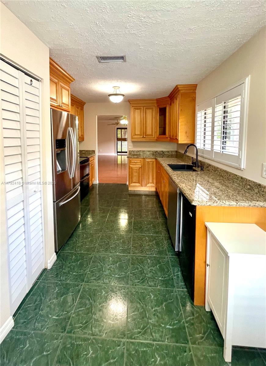 Great investment opportunity. Tenant in place. Call for information! Discover this beautifully upgraded 2-bedroom, 2-bath corner unit on the second floor, nestled in the Gardens of Pine Island Ridge community. Featuring real wood cabinets, granite countertops, SS appliances, a double oven, and an in-unit washer and dryer. Enjoy golf course views from the screened patio, plus extra storage and a large attic space. A/C - 2019, and a tankless water heater 2021. HOA includes golf membership w/NO equity, cable, water, garbage removal, lawn, and more. HOA requires a minimum credit score of 650. Enjoy country club amenities. A+ schools, close to shopping & restaurants and easy access to major highways: 595, I-95, Turnpike.
