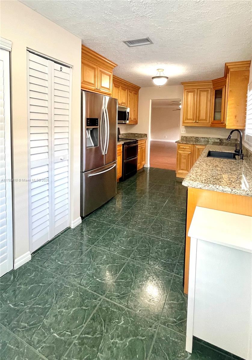 Owner motivated. Call for appointment today! Discover this beautifully upgraded 2-bedroom, 2-bath corner unit on the second floor, nestled in the Gardens of Pine Island Ridge community. Featuring real wood cabinets, granite countertops, SS appliances, a double oven, and an in-unit washer and dryer. Enjoy golf course views from the screened patio, plus extra storage and a large attic space. A/C - 2019, and a tankless water heater 2021. HOA includes golf membership w/NO equity, cable, water, garbage removal, lawn, and more. HOA requires a minimum credit score of 650. Enjoy country club amenities. A+ schools, close to shopping & restaurants and easy access to major highways: 595, I-95, Turnpike. Easy to show.
