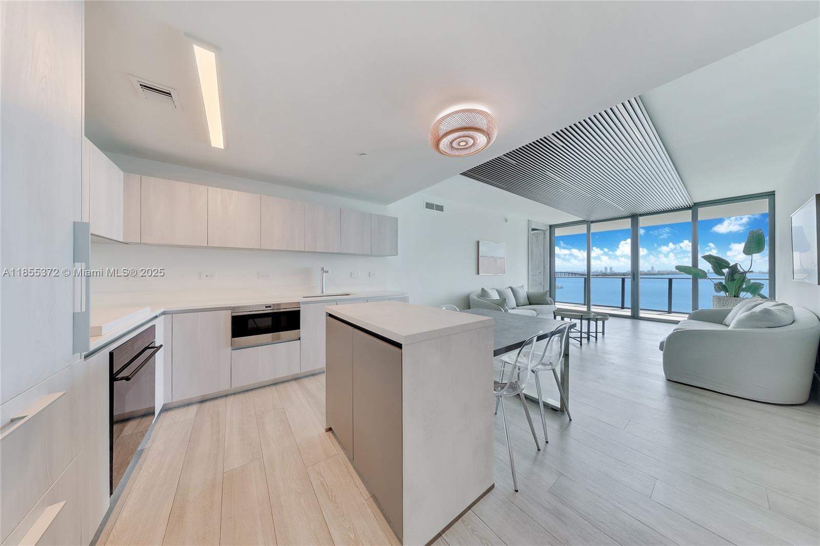 Experience the best of Miami living in this 3 bedroom, 3.5 bath bayfront residence at One Paraiso. A private elevator foyer opens to sweeping Biscayne Bay views, floor to ceiling glass, and a direct bayfront balcony ideal for entertaining. Offered partially furnished with designer upgrades, the home features a sleek chef’s kitchen, spa-inspired primary suite with walk-in closet, en-suite bedrooms, and a versatile den/office. One Paraiso offers world-class amenities including a waterfront pool, spa, fitness and yoga center, tennis courts, and its own acclaimed restaurant. Minutes from the Design District, Brickell, and Miami Beach, this residence includes one assigned parking space, valet, and services covering water, cable, and internet.