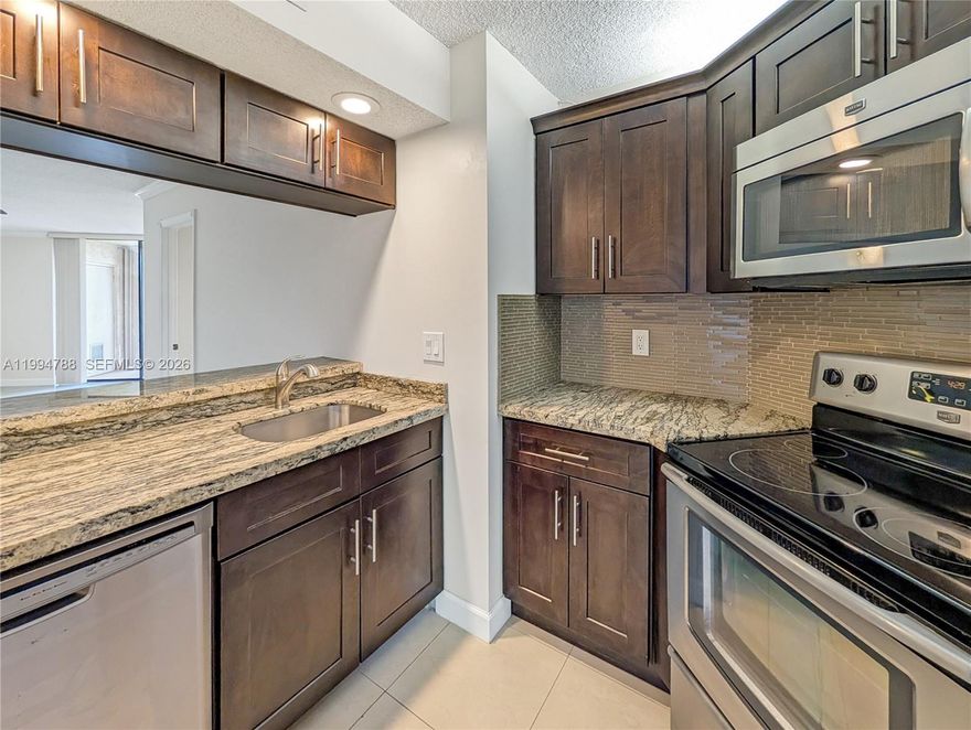 Rare opportunity to own the best-priced unit in Plantation Racquet Club - and it shows. Perched on the highest floor, this stunning 2BD/2BA condo delivers breathtaking sunsets, pool, and tennis court views from your private balcony. At 950 sqft, the layout is open, flowing, and surprisingly unique - nothing cookie-cutter here.

Inside, you'll find crown molding throughout, an abundance of natural light, generous closet space throughout, washer and dryer in the unit, and a private storage room - the details that make everyday living effortless. Every window is equipped with accordion shutters for full storm protection and peace of mind. The building itself is a standout: spa, pool, 4 tennis courts, ample parking, and private security on-site every night — all within a well-run association with HOA dues covering water and, best of all, FULLY FUNDED reserves.

Location is unbeatable. One block from American Heritage School, minutes to Sawgrass Mills, Central Park, University Drive, I-75, I-595, 20 minutes drive to FLL & beaches, and a full lineup of restaurants and shopping. Whether you're a first-time buyer, investor, or downsizing - this one checks every box. Move fast.
