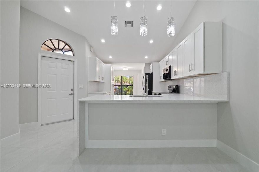 Discover redefined luxury in this fully remodeled 2-bedroom, 2-bath residence in the heart of Boca Raton. Every detail is crafted for comfort and sophistication: an open kitchen with an island, breakfast nook, stainless steel appliances, and gleaming porcelain tile floors. A bright sunroom opens to a screened patio, perfect for relaxing outdoors. The spacious primary suite features a large walk-in closet and a spa-inspired bath with a luxurious soaking tub, glass shower, and dual sinks. The home also includes a garage, ensuring convenience and security. Nestled in a gated community just minutes from beaches, upscale shopping, and fine dining, this is the epitome of a sophisticated lifestyle. Don’t miss this rare opportunity.