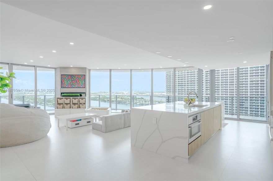 Experience an extraordinary “mansion in the sky” at Aria on the Bay. This rare double residence, originally 6 beds/6 baths, has been masterfully reimagined into 4 grand bedrooms, 5 spa-like baths, a state-of-the-art media room, elegant office, and 2 expansive living areas designed for entertaining. Encompassing nearly 6,000 sq. ft., including a spectacular 1,200+ sqft balcony with 180° views, features 4 parking spaces and private elevator entry. Floor-to-ceiling glass with panoramas of Biscayne Bay, South Beach, and the Atlantic. Indulge in world-class amenities two resort-style pools, a modern fitness center, spa, theater, lounge, and more. Positioned just steps from Margaret Pace Park, near premier marinas, Wynwood, and the Design District, with the airport and beaches only minutes away.