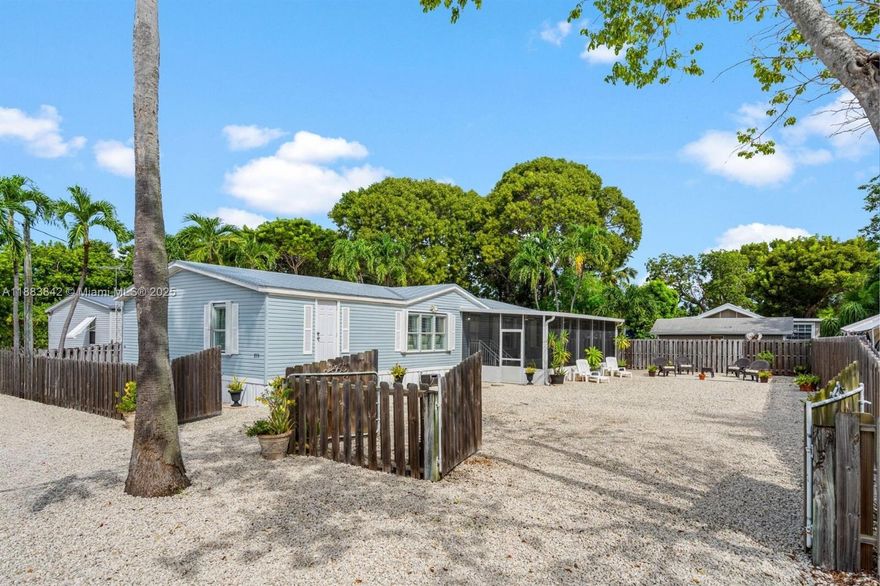 Welcome to this charming Key Largo property—ideal as a primary residence, vacation getaway, or short-term rental (28-day minimum). Offered furnished or unfurnished, this manufactured home features an open floor plan with four bedrooms, two bathrooms, and ample closet and storage space throughout, as well as a utility room for the washer and dryer. Recent upgrades include stainless steel appliances and a newer metal roof. Set on an oversized lot, the property features a spacious screened-in patio, perfect for relaxing or entertaining. The fenced yard, complete with dual 12-foot gates, easily accommodates a large boat, RV, or both. Just one block away, residents have exclusive access to a private boat ramp—making it effortless to enjoy endless adventures on the water.
