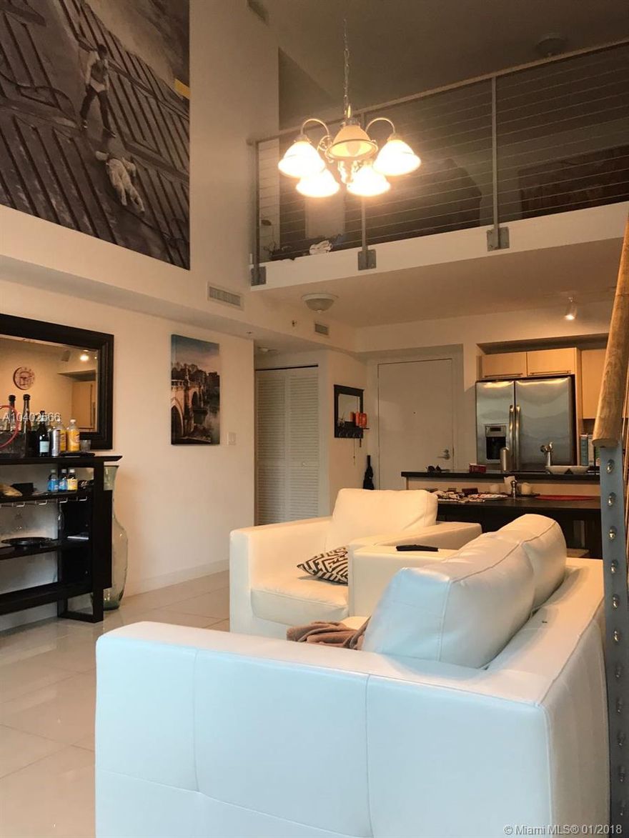 Spectacular bi-level townhome unit with 2 bed/ 2 baths plus a den with porcelain floors in first level and large private patio .High ceilings with panoramic glass windows that extend from floor to ceiling. The European-style kitchen has stainless steel appliances, Italian cabinetry, and imported countertops.Two parking spots (tandem) are included plus storage.