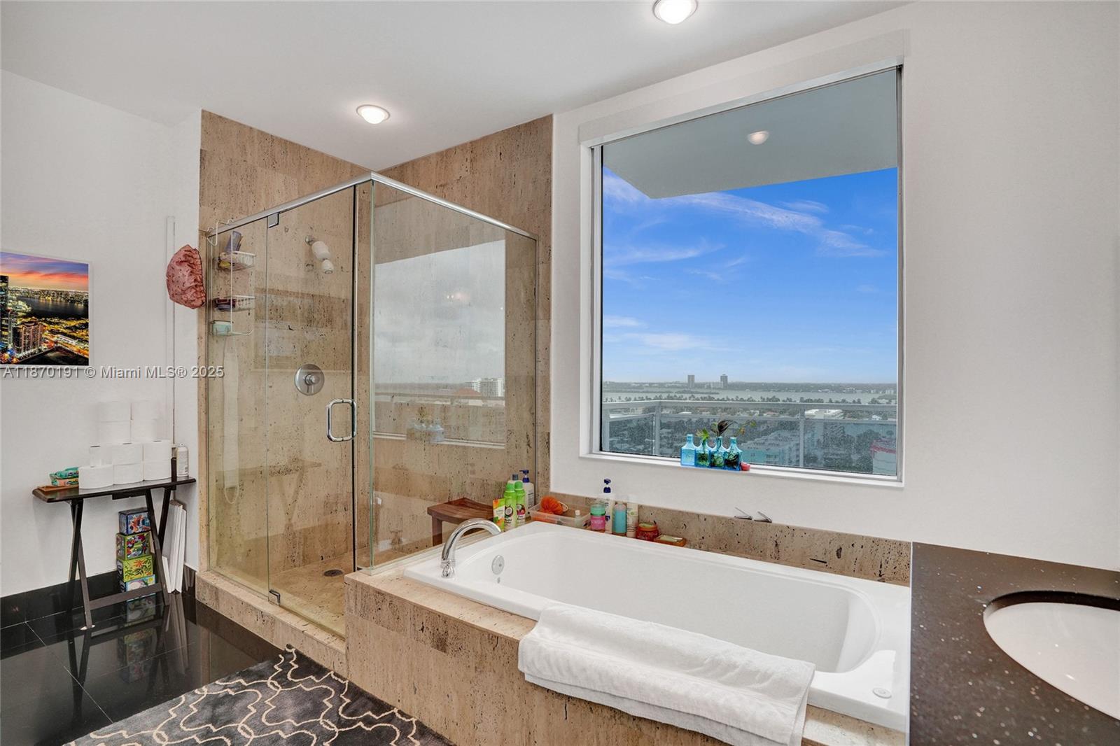 Step into a home where every day feels like a getaway. This renovated 2BD+Den,3BA corner residence spans nearly approx. 1750 SF with soaring 10.ft ceilings and a 600 SF wraparound balcony framing dazzling bay & skyline views. Light pours through impact glass doors onto sleek white porcelain floors,while smart-home features,motorized shades,a chic Italian kitchen with new appliances create effortless living. The primary suite offers a spa-like bath with jetted tub, glass shower & picture window overlooking downtown. Den is converted to a 3rd bedroom with its own full bath. The Lexi delivers resort-style amenities: infinity pool, modern gym & 24 hr. security. Ready to move in and start your waterfront lifestyle!