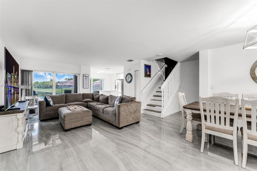 Beautifully remodeled townhome in the desirable Lake Avila community of West Kendall featuring impact windows throughout, new A/C, and a new water heater. This home offers a functional open layout with bright living and dining areas and gorgeous lake views, creating a peaceful and inviting setting.

Upstairs features four bedrooms, including a den that was converted into an additional bedroom, providing flexible living space ideal for larger families or home office needs. The primary suite offers ample space and tranquil water views. The garage has been converted into an additional room with its own A/C vent, perfect for extended living, guest space, or storage flexibility.

Enjoy serene lakefront living along with community amenities including a pool, green spaces, low HOA fees, and convenient access to shopping, dining, schools, and major highways. Move-in ready and ideally located—this is a rare opportunity in West Kendall.