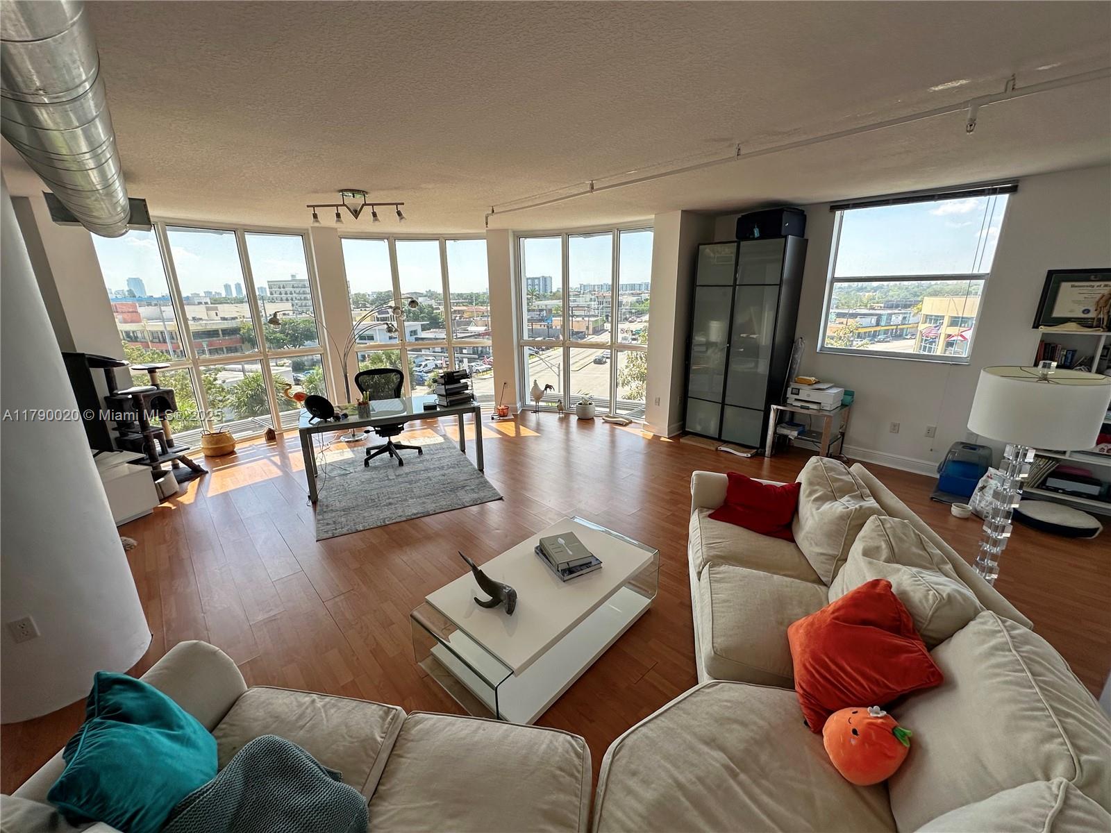 Step into this spacious 1-bed, 1-bath corner loft featuring 1,273 sq ft of airy, flexible living. Zoned for live/work, it's an ideal setup for creatives, remote professionals, or anyone seeking a stylish studio-style layout.
The soaring ceilings and iconic circular wall of windows flood the space with natural light and offer panoramic city views—including Marlins Stadium. The modern kitchen comes equipped with a new fridge, microwave, dishwasher, and in-unit laundry, plus a 2020 A/C for added comfort.
Enjoy a private balcony, along with two assigned garage parking spaces located on the same level. The building offers 24/7 security, a fitness center, and a sun deck for relaxing above the city buzz.
Move-in special: Reduced security deposit!