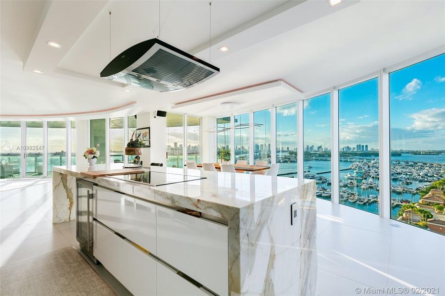 Spectacular ultra-modern unit with impeccable views from every corner offers designer upgrades such as 120" home theater, Veneta Cucine top of the line kitchen, Calacatta gold marble kitchen counters. Best line in the building with an immaculate open layout with floor to ceiling glass windows, private elevator entry, 700 sq ft of extra deep terrace to enhance outdoor living and views of the bay, Fisher Island, Miami Skyline, Miami Beach Marina, city and beach. All complemented by one of South Beach's best known and most luxurious condo residences "The Murano at Portofino"