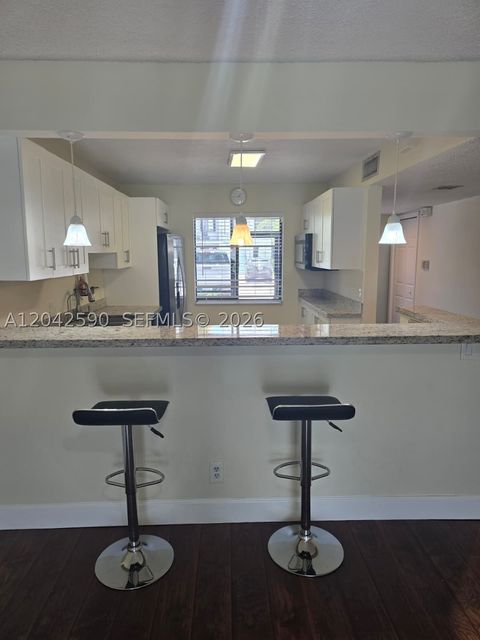 Photo of 16581 Blatt Blvd #104, Weston, FL 33326 (MLS # A12042590)