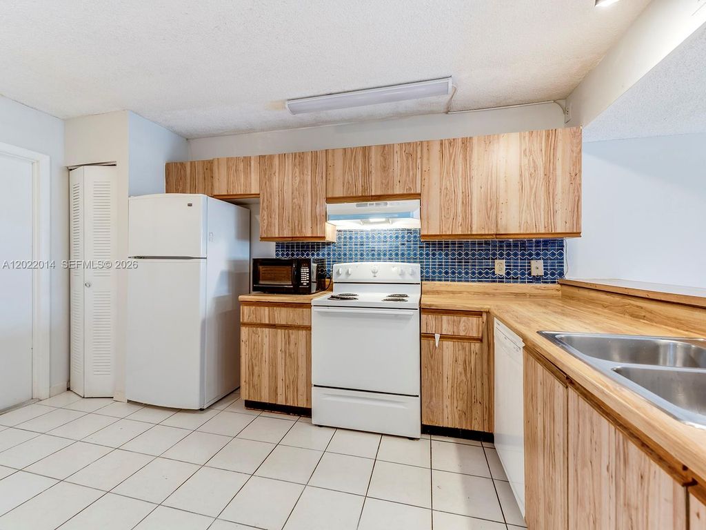 Photo of 1351 NW 124th Ave #1351, Pembroke Pines, FL 33026 (MLS # A12022014)